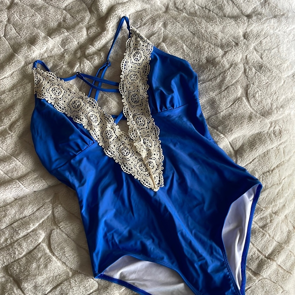 Worn once One piece swim suit- blue with lace deep V adjustable.